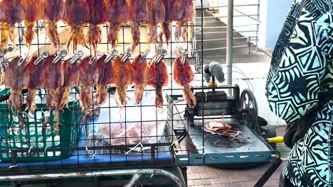 vendor grilling squid at pattaya beachside stall