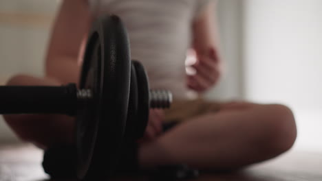 little boy plays with professional workout equipment in gym