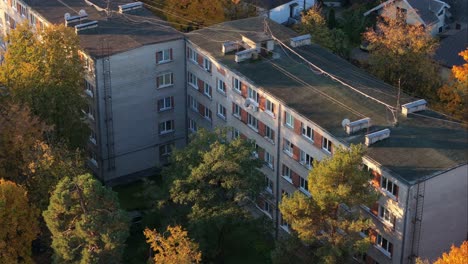 khrushchyovka building in 4k - drone flies closer at autumn sunrise