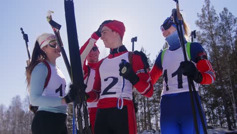 joyous biathlete holding medal and celebrating victory