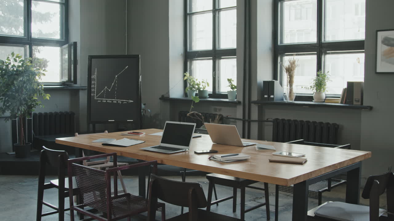Overview of Chalkboard with Business Graph in Coworking Office