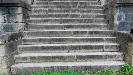 pan up of steep ancient stone stairway steps of ancient yapahuwa rock fortress in sri lanka