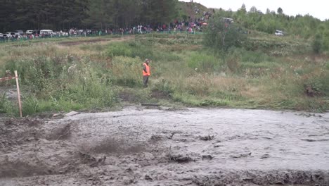 off-road vehicle competition in muddy terrain