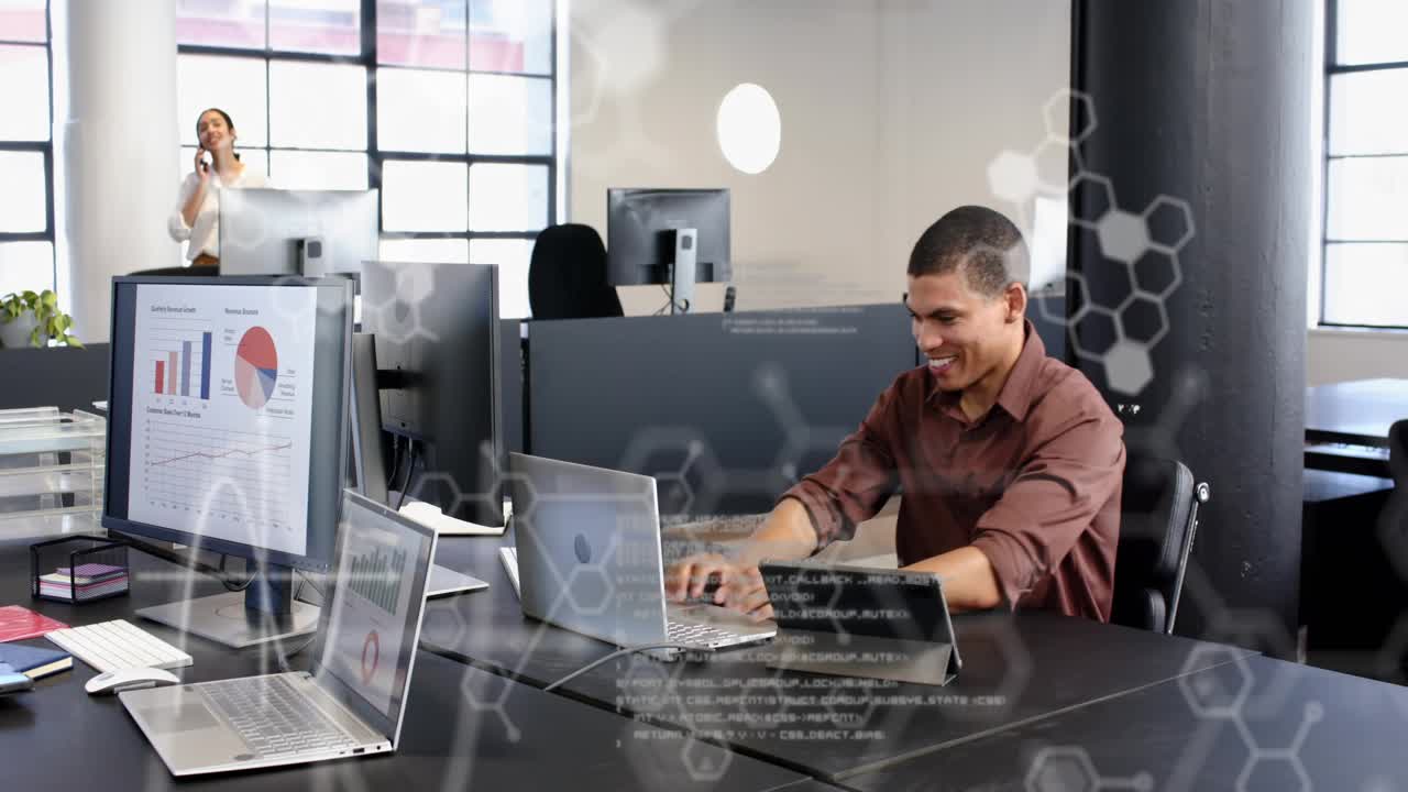 Male office worker coding laptop, cheering after success while hex code overlays tech charts