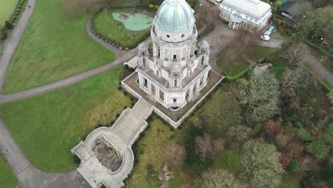 Aerial-view-landmark-historical-copper-dome-building-Ashton-Memorial-English-countryside-high-to-descending-tracking-shot