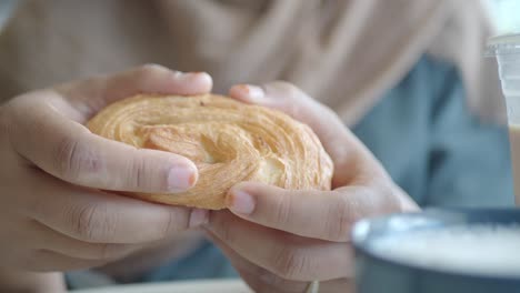 woman eating croissant