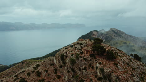 Aerial-View-of-Talaia-d'Alcúdia-Mountain-Overlooking-The-Calm-Sea-in-Mallorca,-Spain