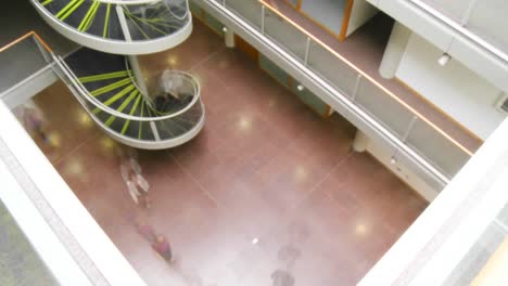 people walking in a business building quickly