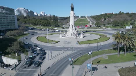 drone shot around the marques de pombal statue, parque eduardo vi park in background, sunny day, in lisbon, portugal