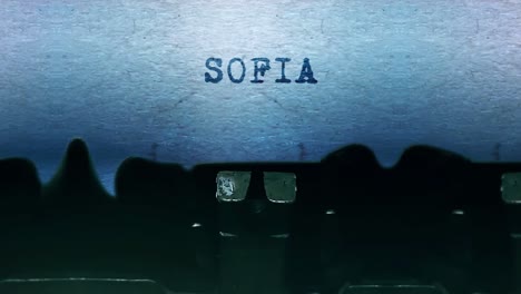 sofia word closeup being typing and centered on a sheet of paper on old vintage typewriter