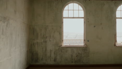 abandoned room with arch window