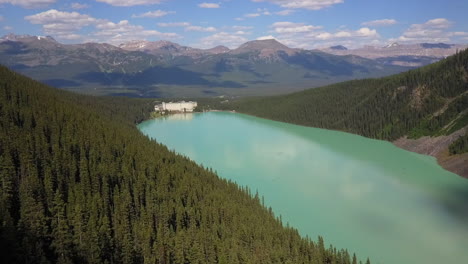 aerial flyover: glacial green lake louise with luxury chateau hotel