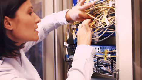 technician checking cables in a rack mounted server