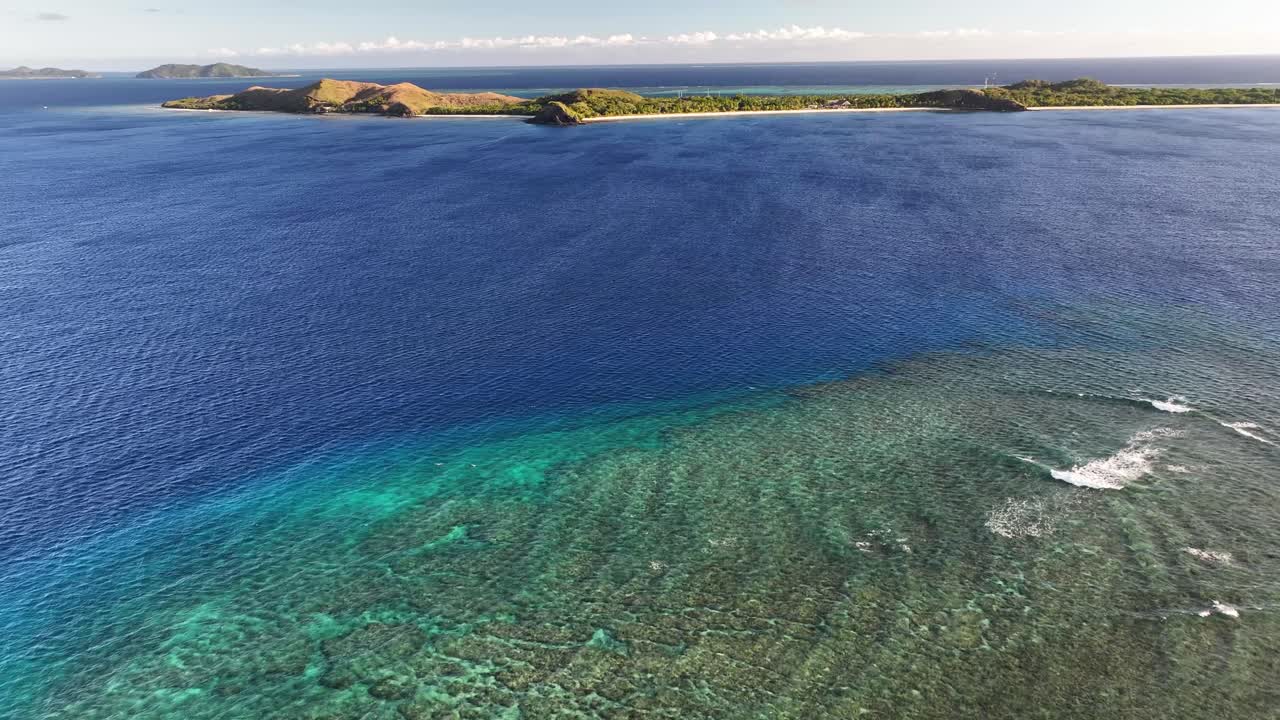 Drone flyover coral reef and crystal clear water in Fiji, famous snorkelling and diving spot.