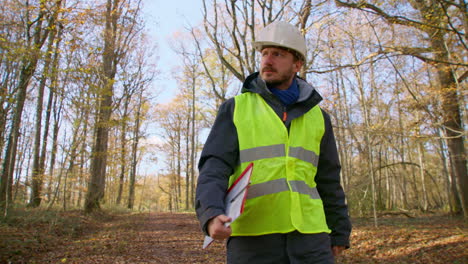 Clipboard-in-hand,-personal-protective-clothing,-leaves-of-Autumn