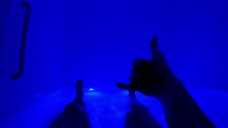 peaceful blue floating experience in saltwater tank, shaka gesture, relaxation