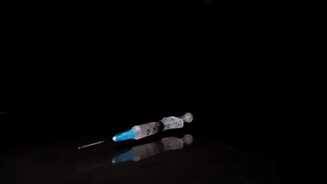 syringe falling and spinning towards camera