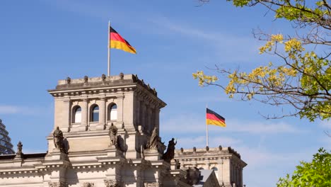 german flags flying on reichstag building