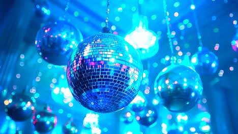 a room with many disco balls hanging from the ceiling. the room is decorated for a party. scene is festive and lively