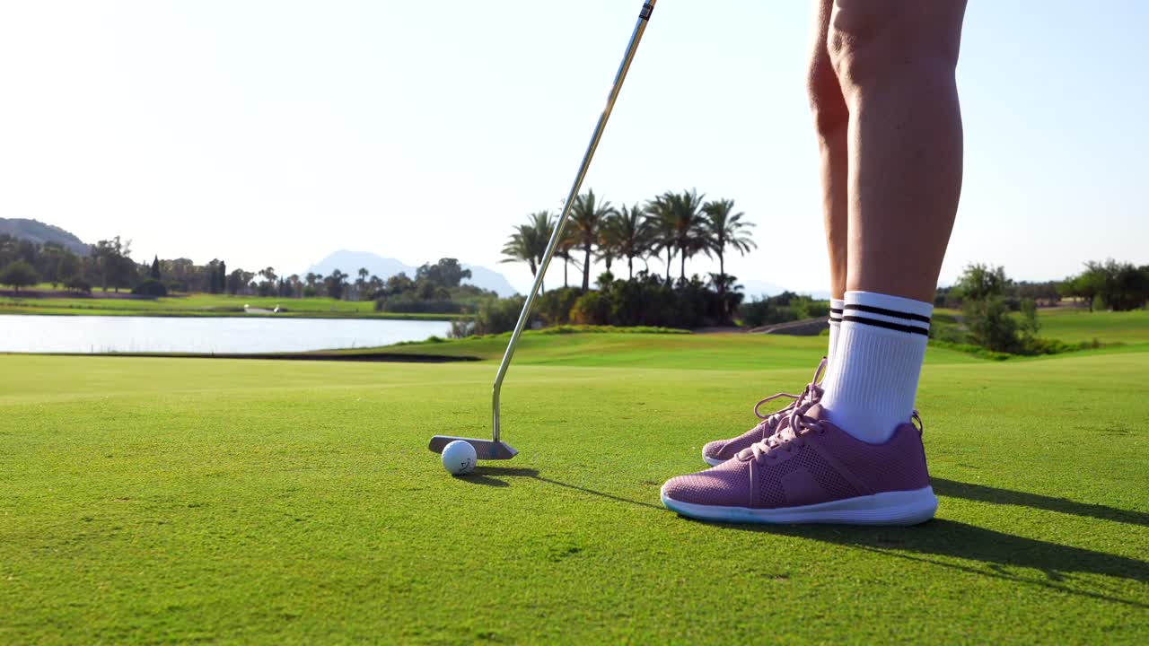 Golfer Putting on Green Golf Course
