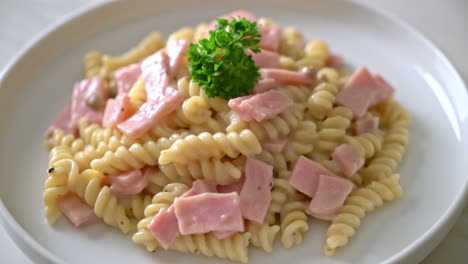 spirali or spiral pasta mushroom cream sauce with ham - italian food style