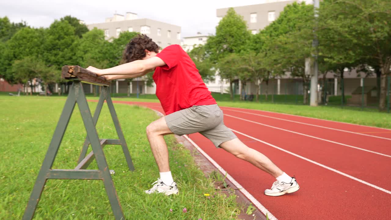 Man Stretching on Track