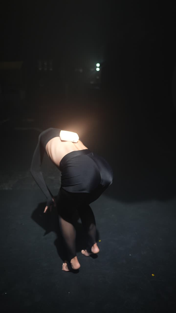 Modern Dance Performance Under Dark Lighting