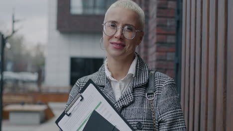 businesswoman outdoors with documents