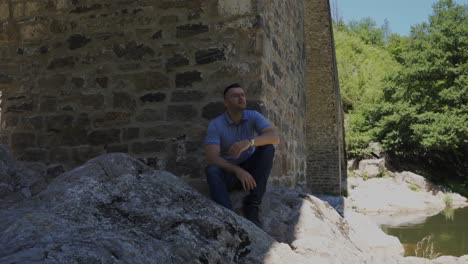 Pedestal-shot-from-the-Arda-River-going-up-to-the-Devil's-Bridge,-located-near-the-Rhodope-Mountains-in-Ardino,-Bulgaria