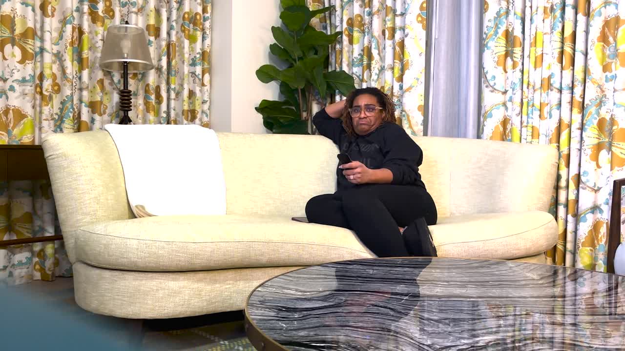 Relaxed Black Woman Watching TV on Sofa Holding Remote Cozy Home