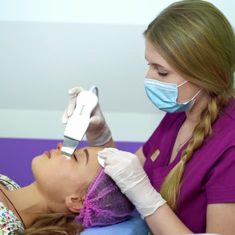 young woman with cosmetic devices in beauty salon
