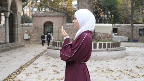 young girl praying courtyard