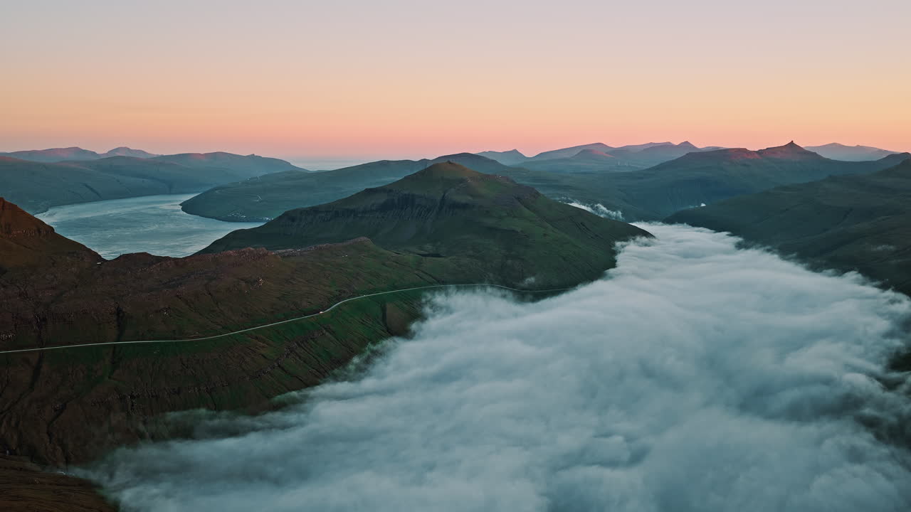 Aerial View of a Foggy Mountain Valley and Fjord at Sunset