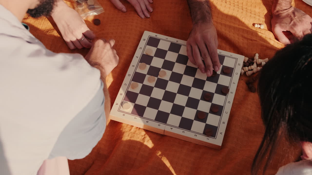 Friends Playing Checkers at a Picnic