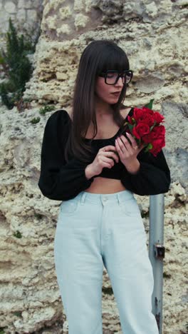 woman outdoor smelling the flowers she received for valentines day