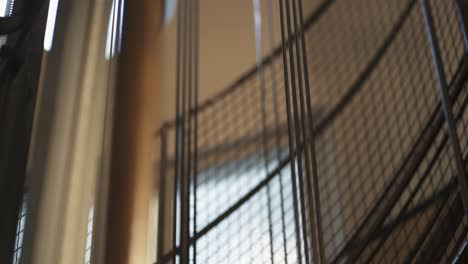 macro shot of lifting cables rising inside a building - close up