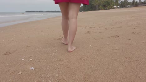 view to bare foot walking on the beach at summer vacation holidays, closeup of legs and feet on white sand beach in slowmotion