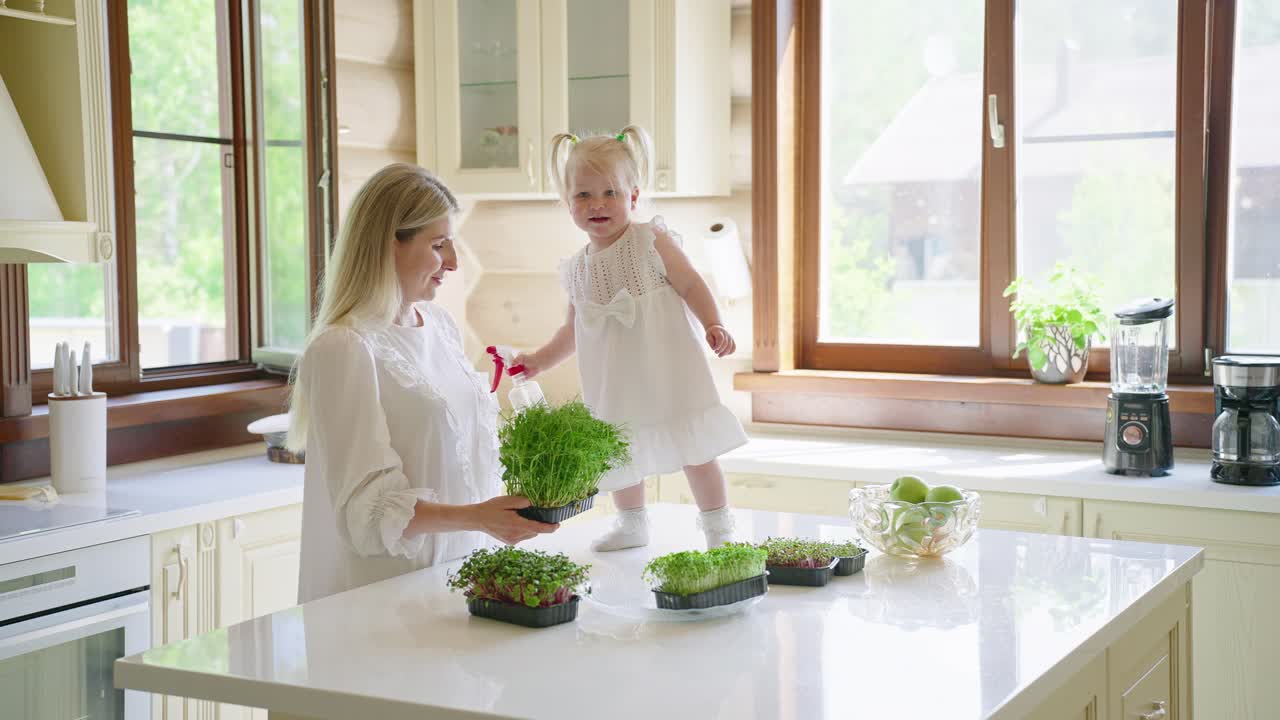 Mother and daughter planting microgreens in the kitchen