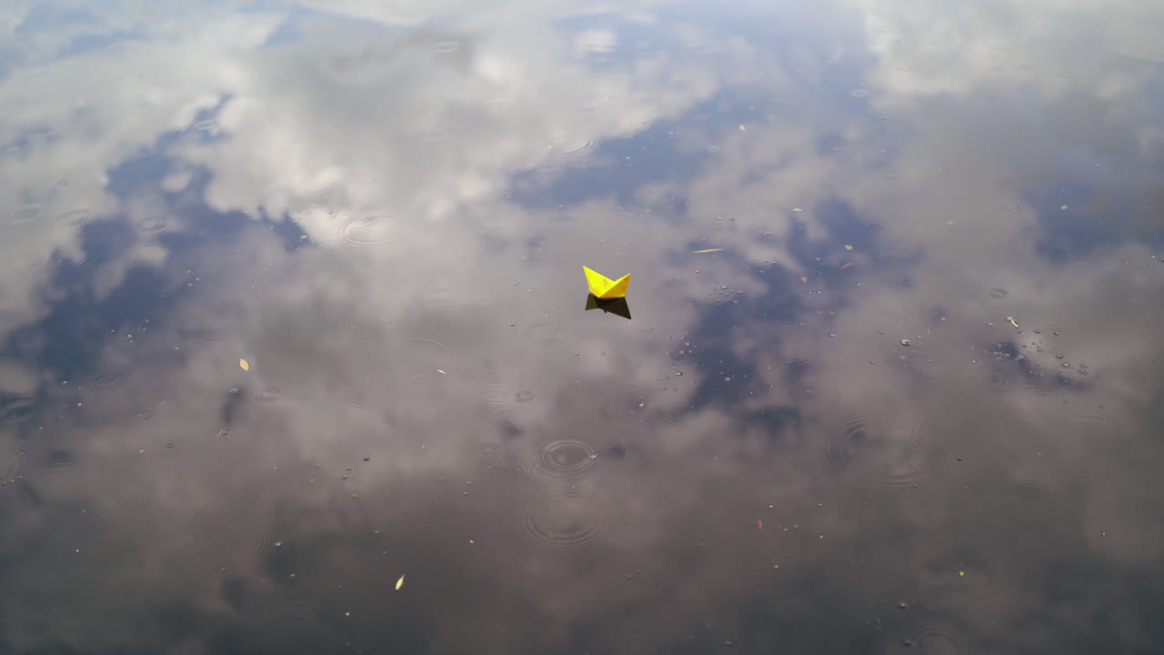 A paper boat floating on the river. Origami ship sailing.
