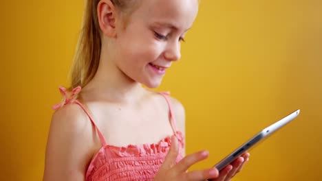 schoolgirl using digital tablet in classroom