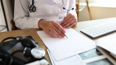 doctor reviewing patient medical records including an ecg
