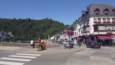 people enjoying the city center of bouillon along river semois in the ardennes - belgium