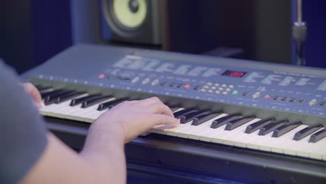 a musician sits at a piano keyboard and plays music