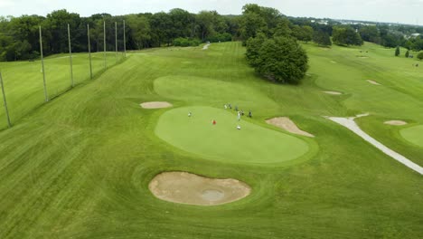 drone footage of golfer on putter green