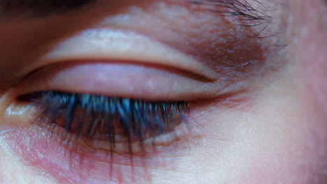 close-up of a human eye reflecting city lights at night