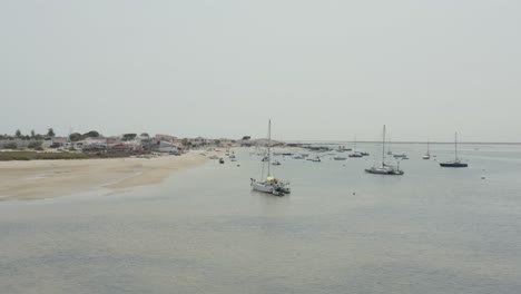 sailboats on the coast of armona island in algarve, portugal