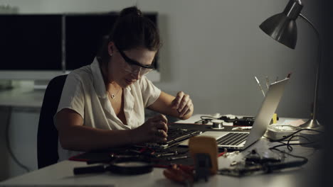 woman repairing a laptop