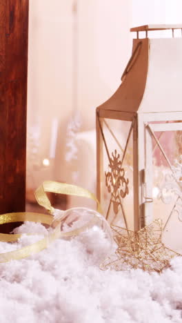 pine cone and lantern decoration on fake snow