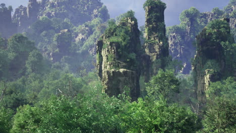majestic rock formations tower over lush green forests at dawn