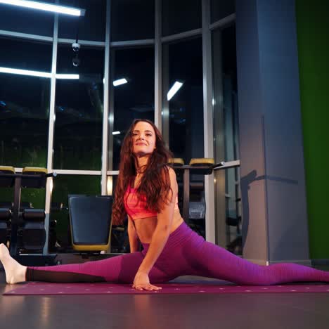 smiling sporty woman stretching at gym. healthy lifestyle. fitness, pilates